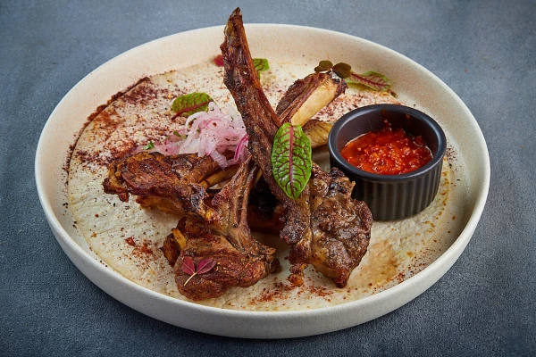 Каре из молодого ягненка с луком ялта и соусом «Аджика»